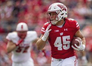 Ingold running with football