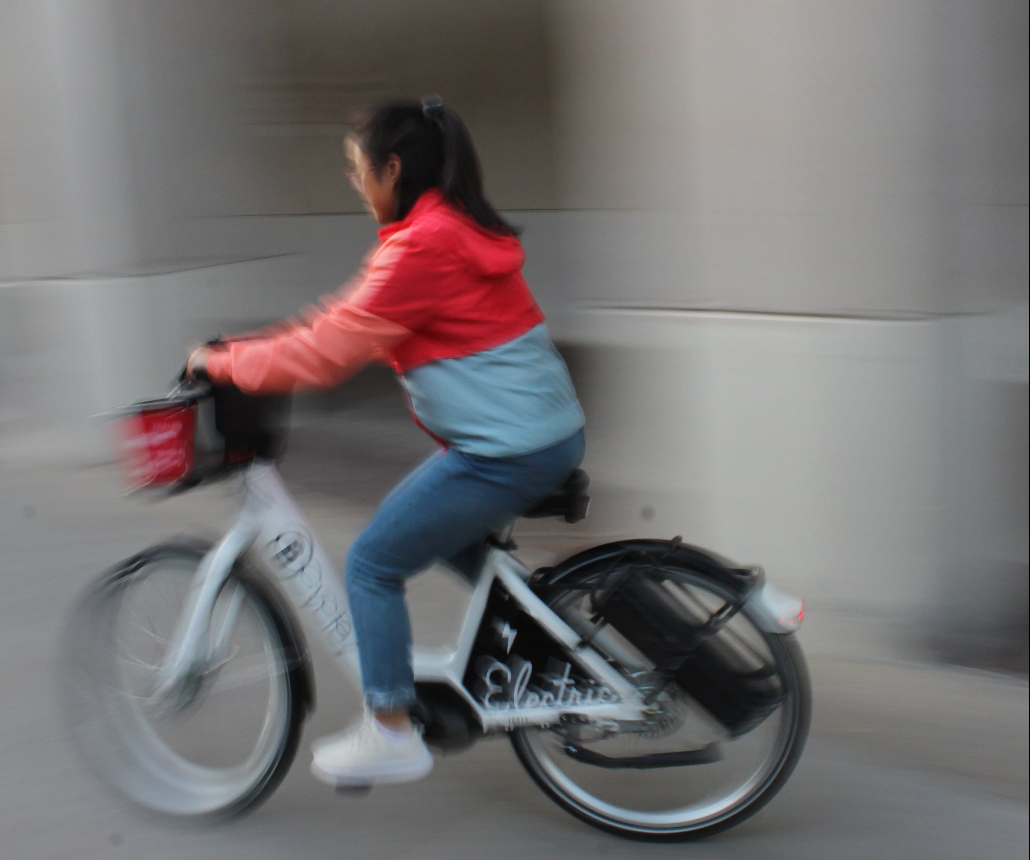 A college student rides an e-bike in Madison