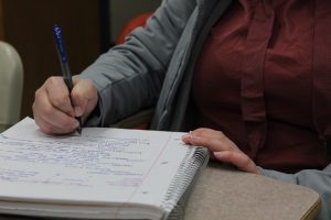 Samantha Cailey writes in a notebook