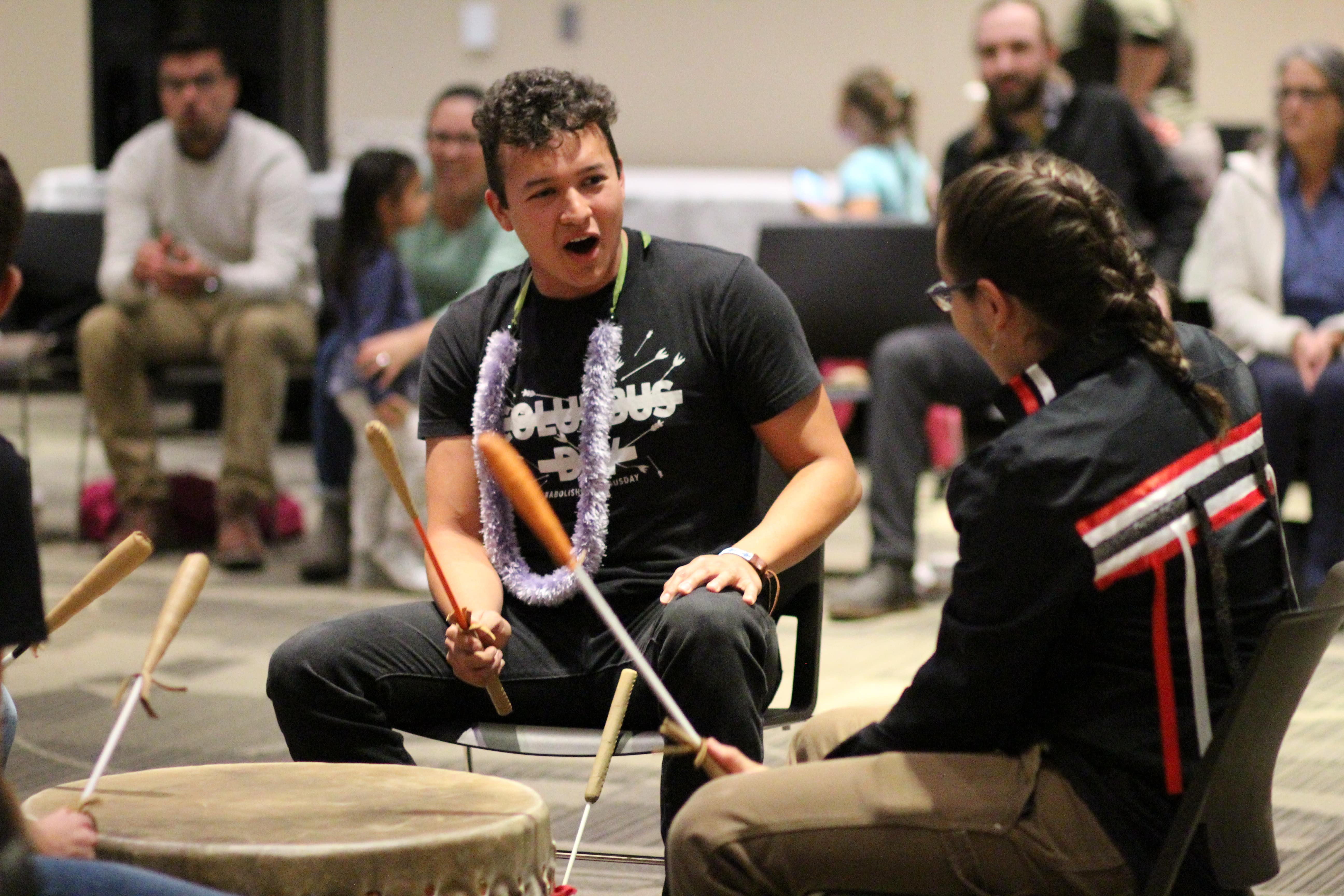 Gudino and Williams participate in a drum circle