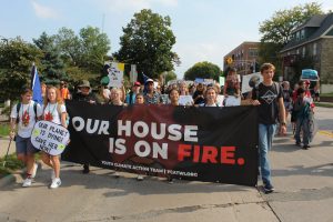 Marchers hold a sign saying
